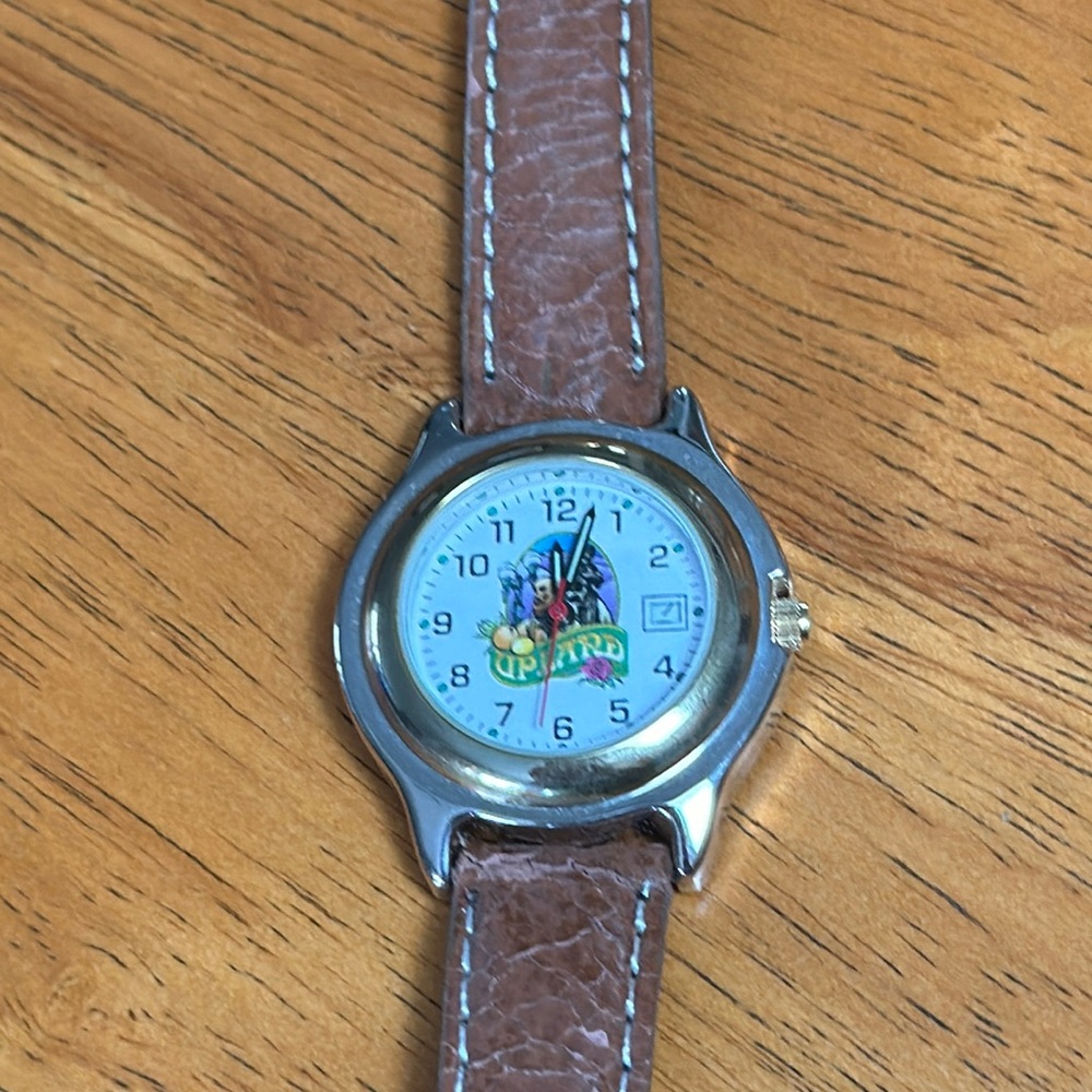Upland watch. City of Upland round face watch with brown faux leather band.
